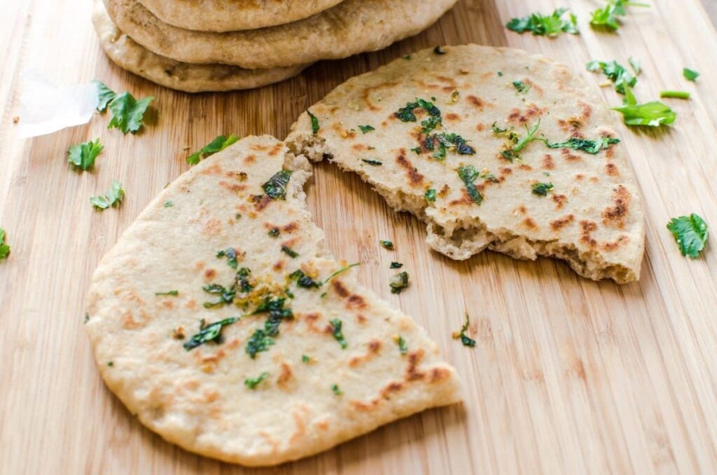 Homemade garlic naan bread for guilty free eating. Made with whole wheat flour and no butter at all.