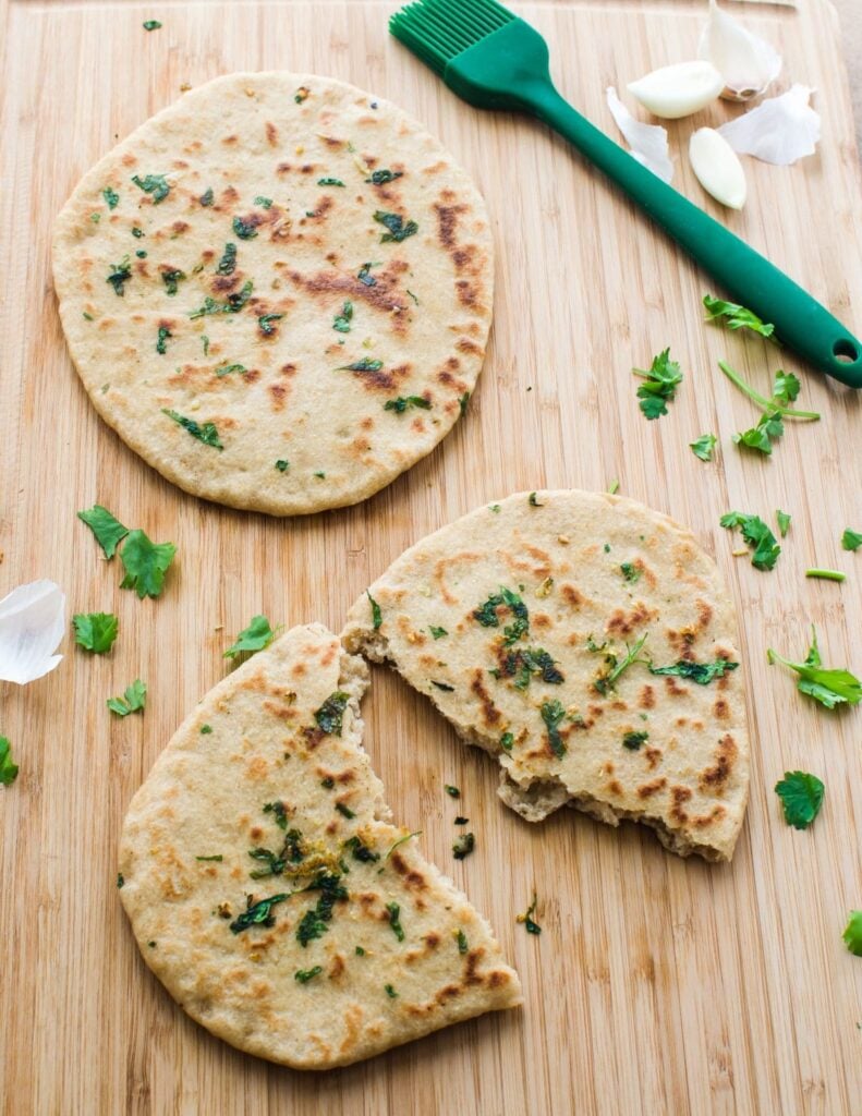 Homemade garlic naan bread for guilty free eating. Made with whole wheat flour and no butter at all.