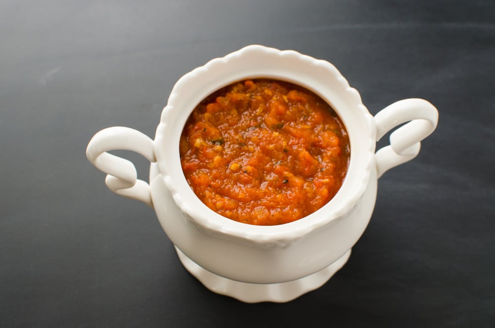 Homemade pizza sauce with fresh tomatoes in bowl.