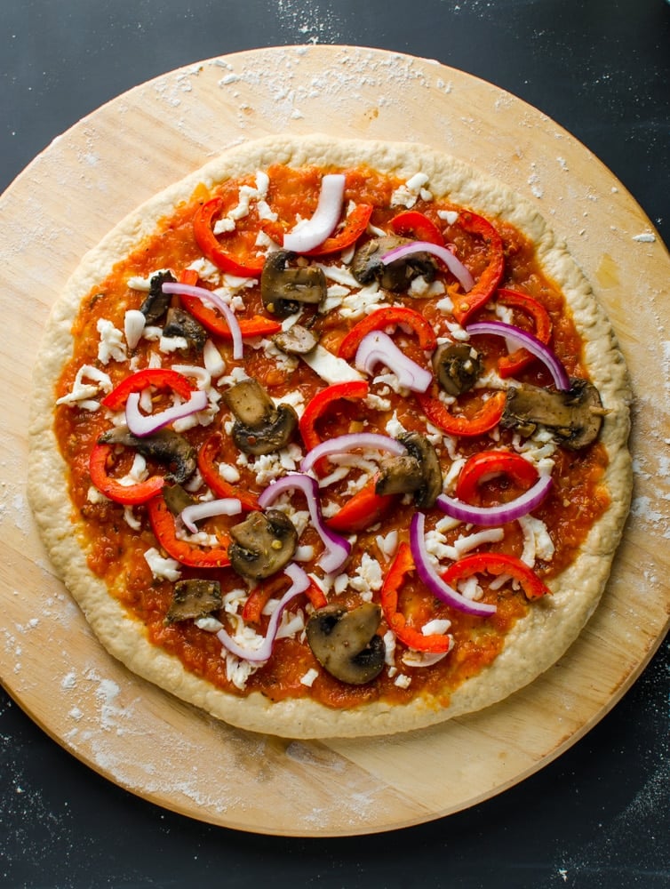 Mushroom tomato pizza before baking.
