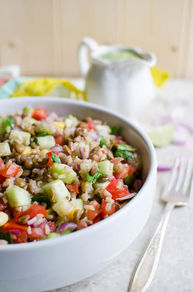 Healthy brown rice salad with lentils and creamy avocado dressing.