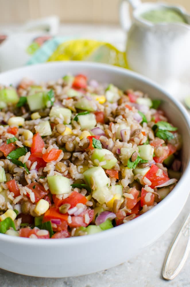 Healthy brown rice salad with lentils and creamy avocado dressing.