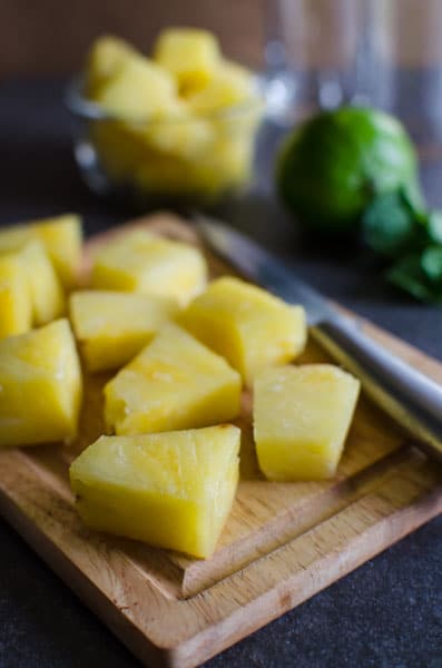 Pineapple pieces on cutting board.