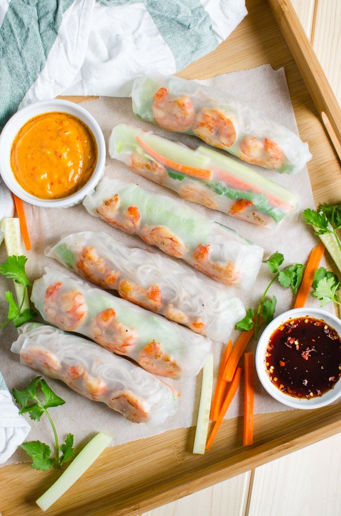 Vietnamese healthy spring rolls with peanut butter sauce and soya sauce dippings on the side in a serving tray.