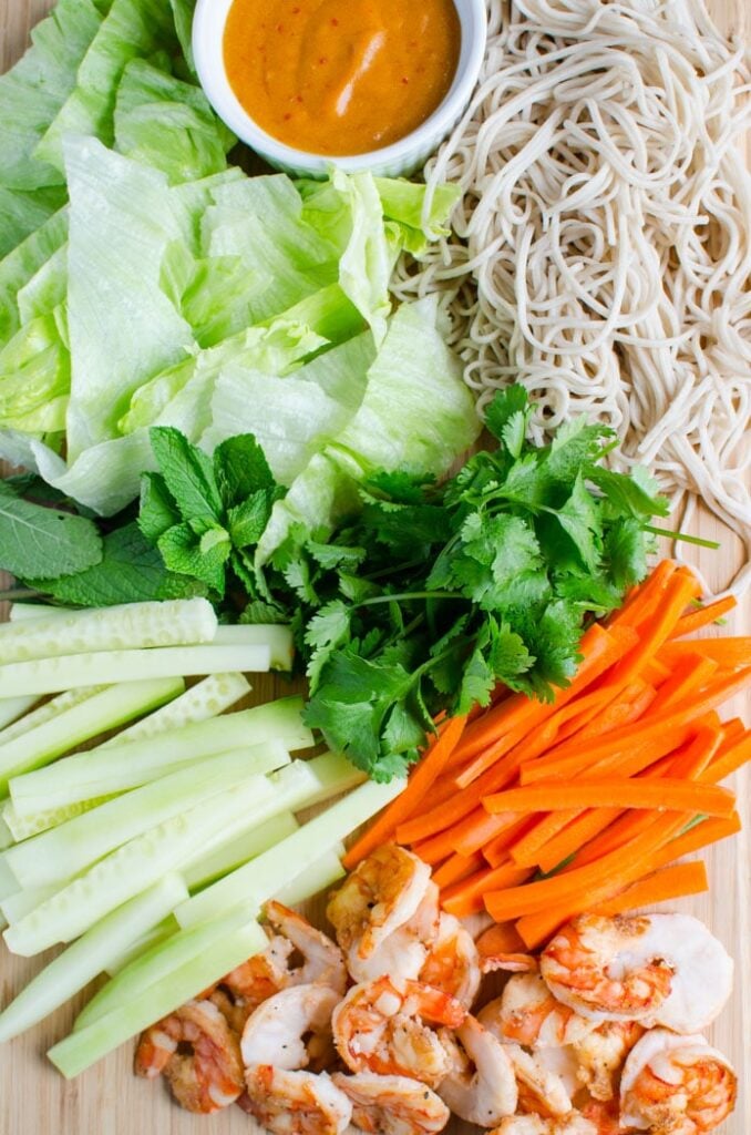 fresh cucumber, carrot, lettuce, herbs and noodles etc ready for making homemade spring rolls.