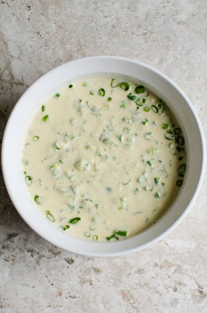 Mung bean and oats batter in a ceramic bowl for making mung bean pancakes.