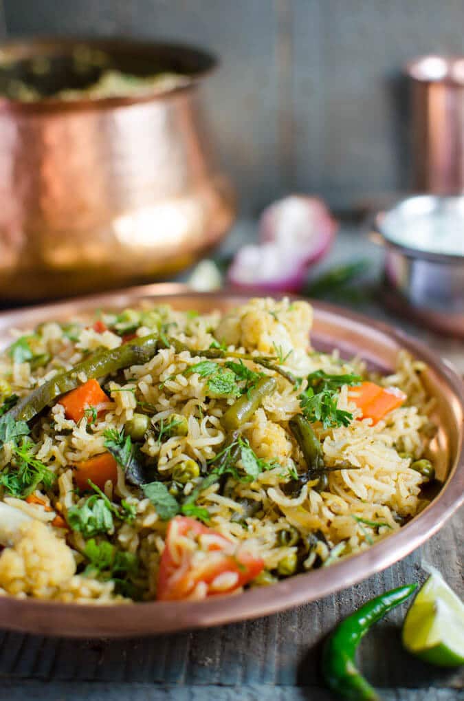 Vegetable biryani in a metal dinner plate.
