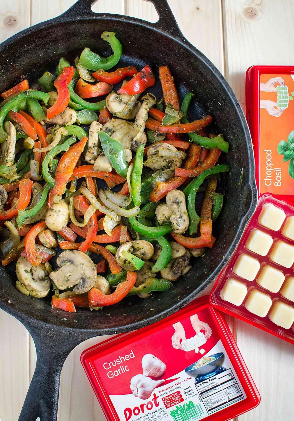 Sliced fresh bell peppers, mushrooms and onion sautéed in a cast iron pan.
