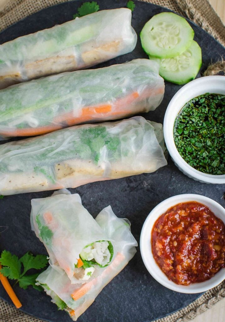 image of Vietnamese healthy vegan spring rolls served with soy sauce and chili sauce on the side.