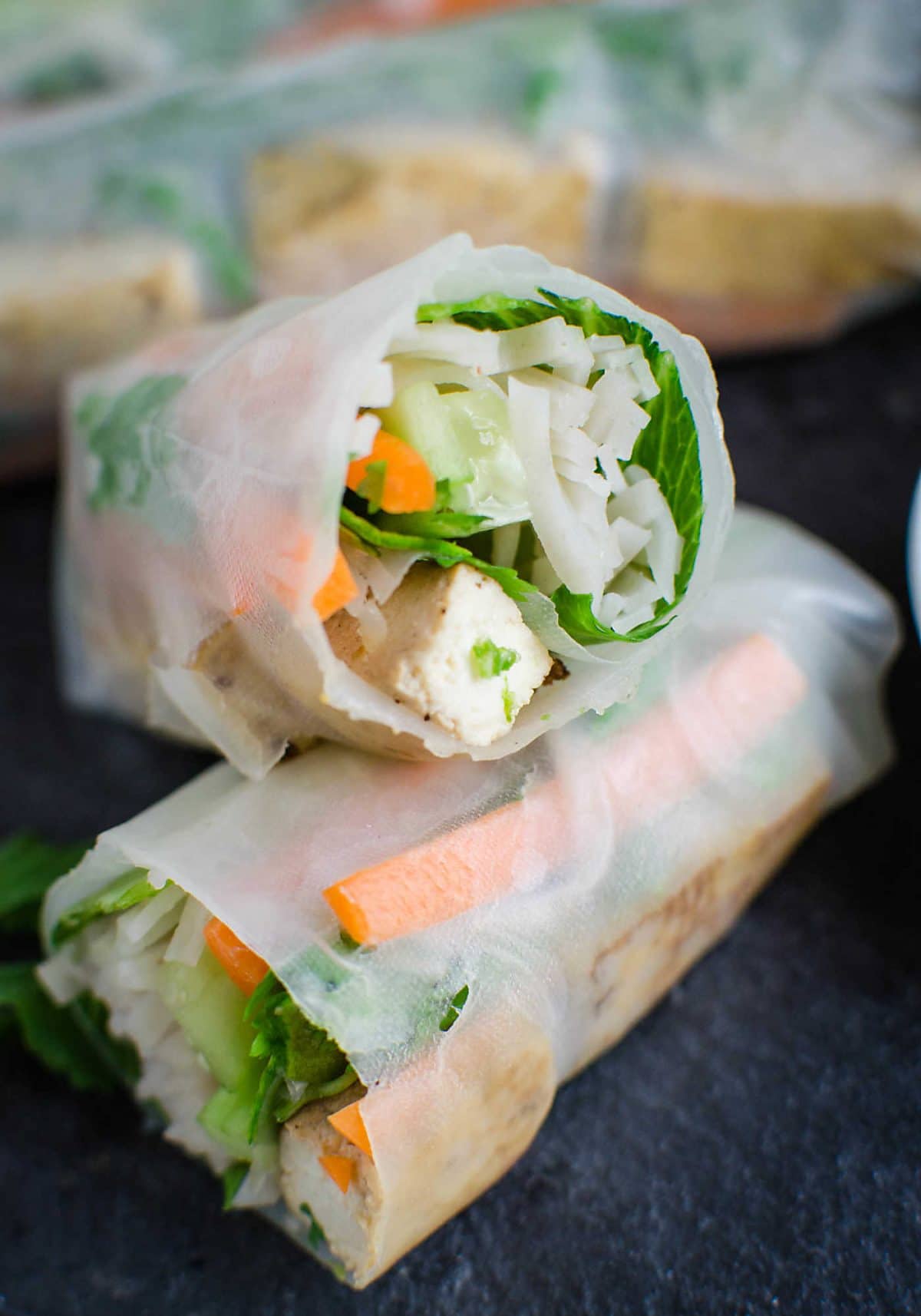 image of healthy tofu spring roll cut into half showing the tofu and noodle fillings. 