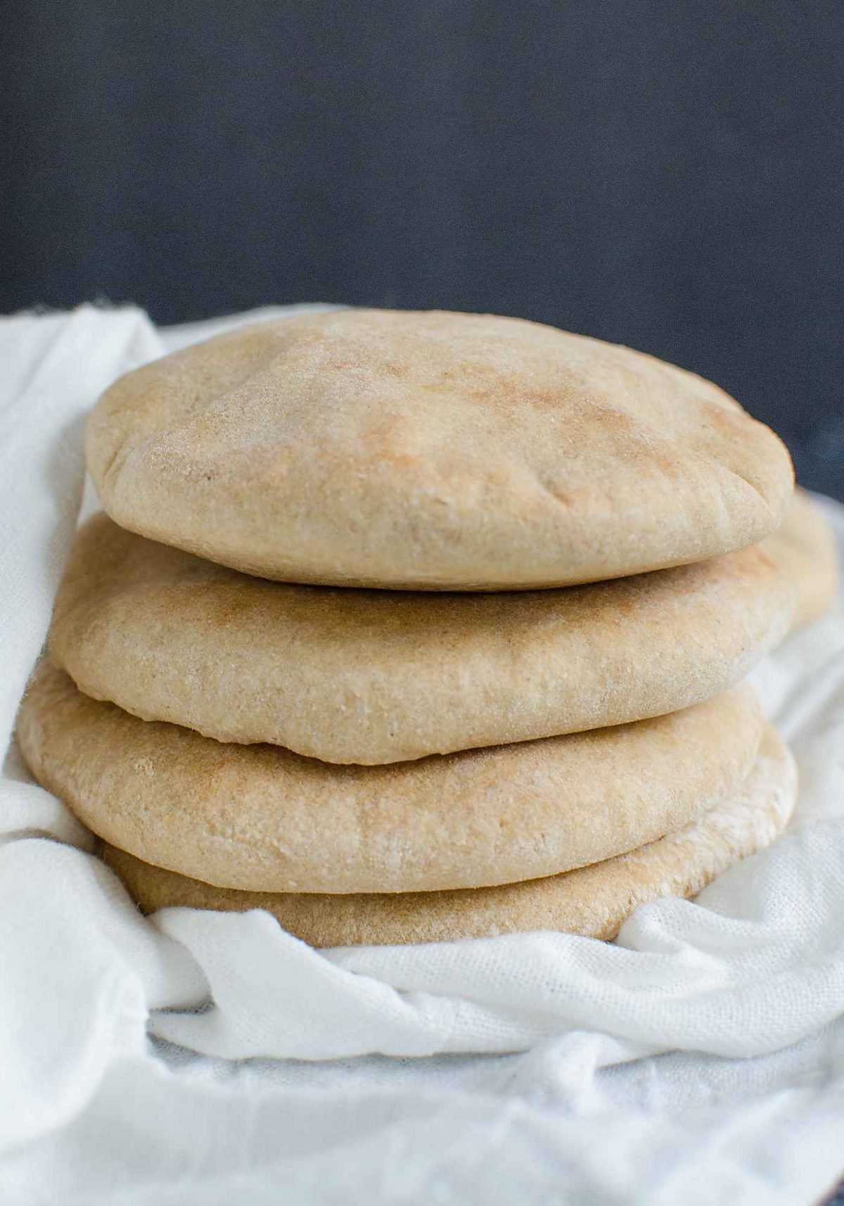 stack of fresh homemade whole wheat pita bread is ready serve. 
