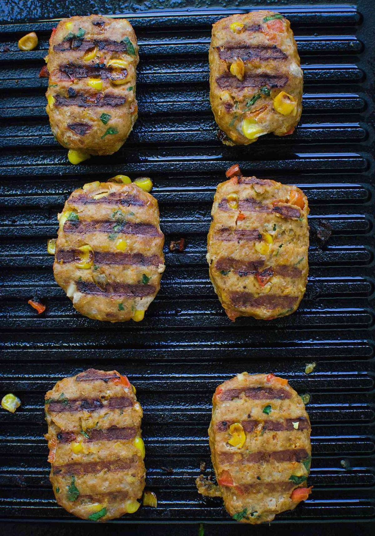 Image with mini turkey meatloaves on the grill while cooking.