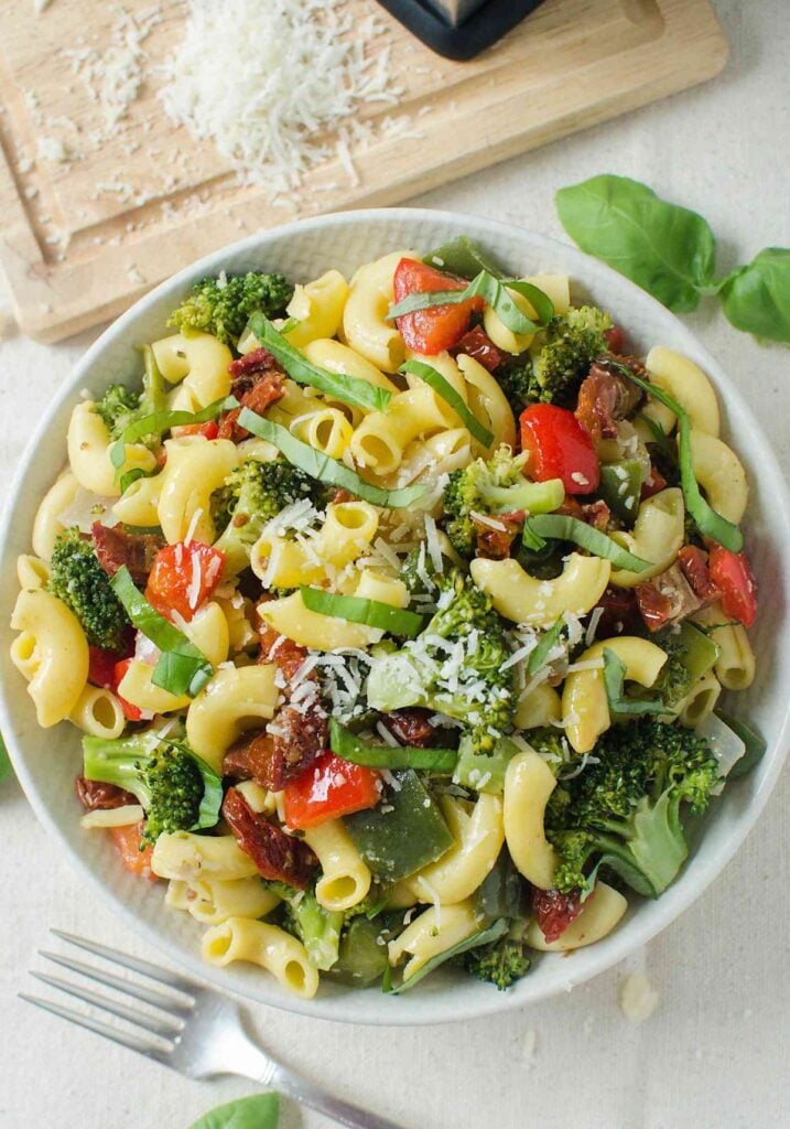 top view image of healthy vegetarian pasta salad with fresh veggies in a serving bowl.