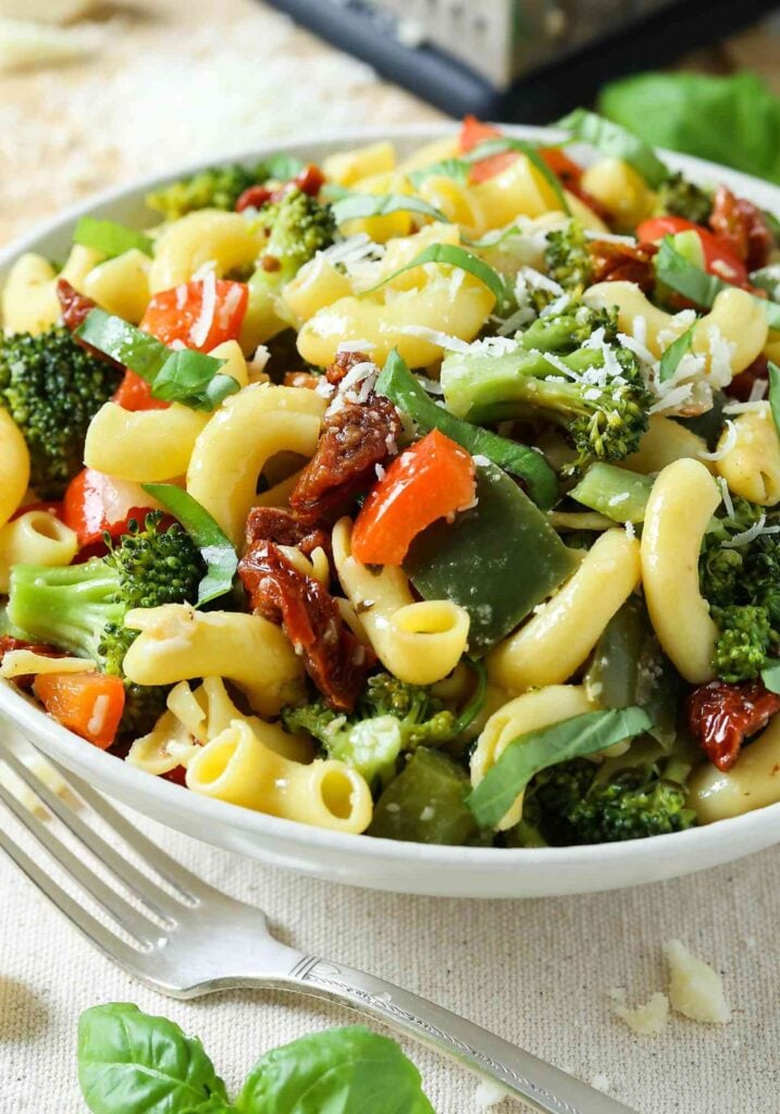 healthy vegetarian pasta salad with fresh veggies in a serving bowl.