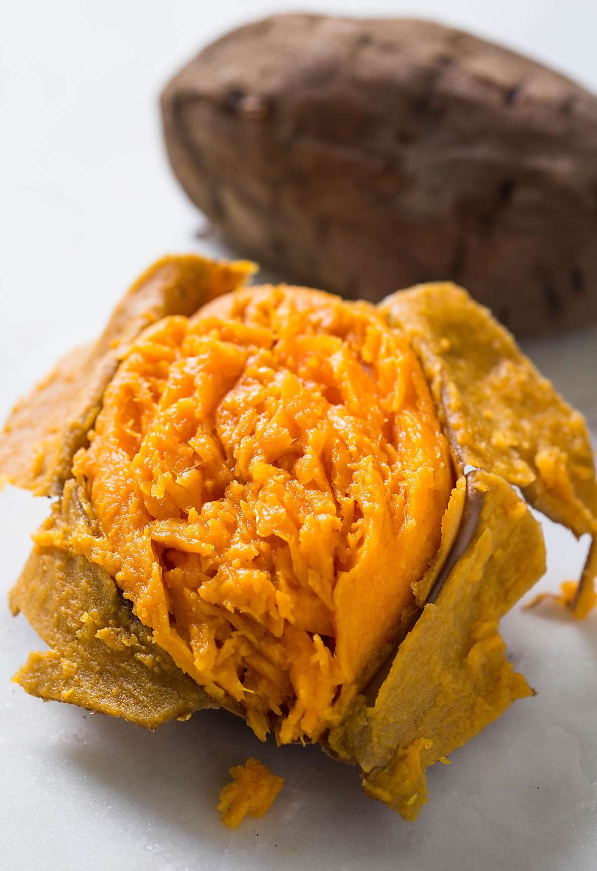 Partially peeled cooked sweet potato.