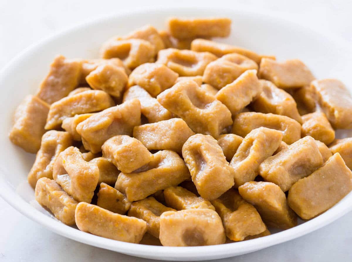 Fully cooked homemade sweet potato gnocchi in a large bowl.