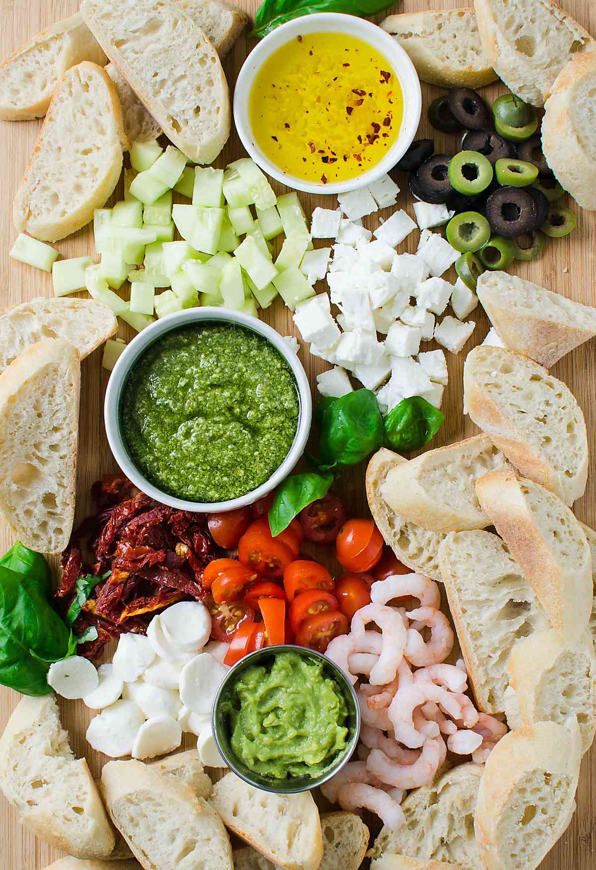 Appetizer board with different ingredients to prepare crostini. 