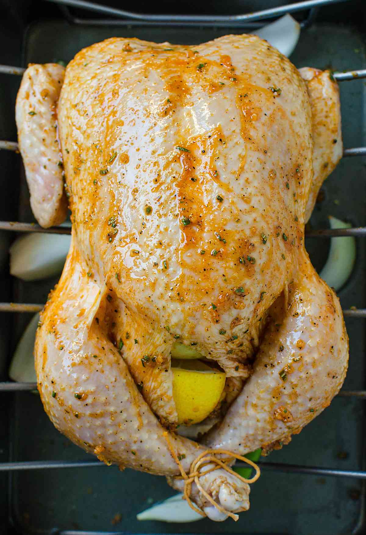 Whole chicken rubbed with herb marinade and stuffed with fresh onion and lemon.