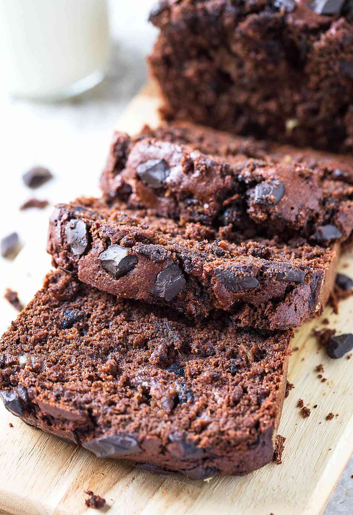 Sliced healthy chocolate oatmeal banana bread on the wooden cutting board.