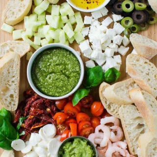 Learn four delicious recipes to make crostini appetizers. You can make it into crostini platter with a variety of toppings that includes bread, pesto, shrimp, tomato, olives, avocado, etc. Perfect party appetizers for holiday or family gatherings. | #watchwhatueat #partyappetizer #thanksgivingappetizer #crostini