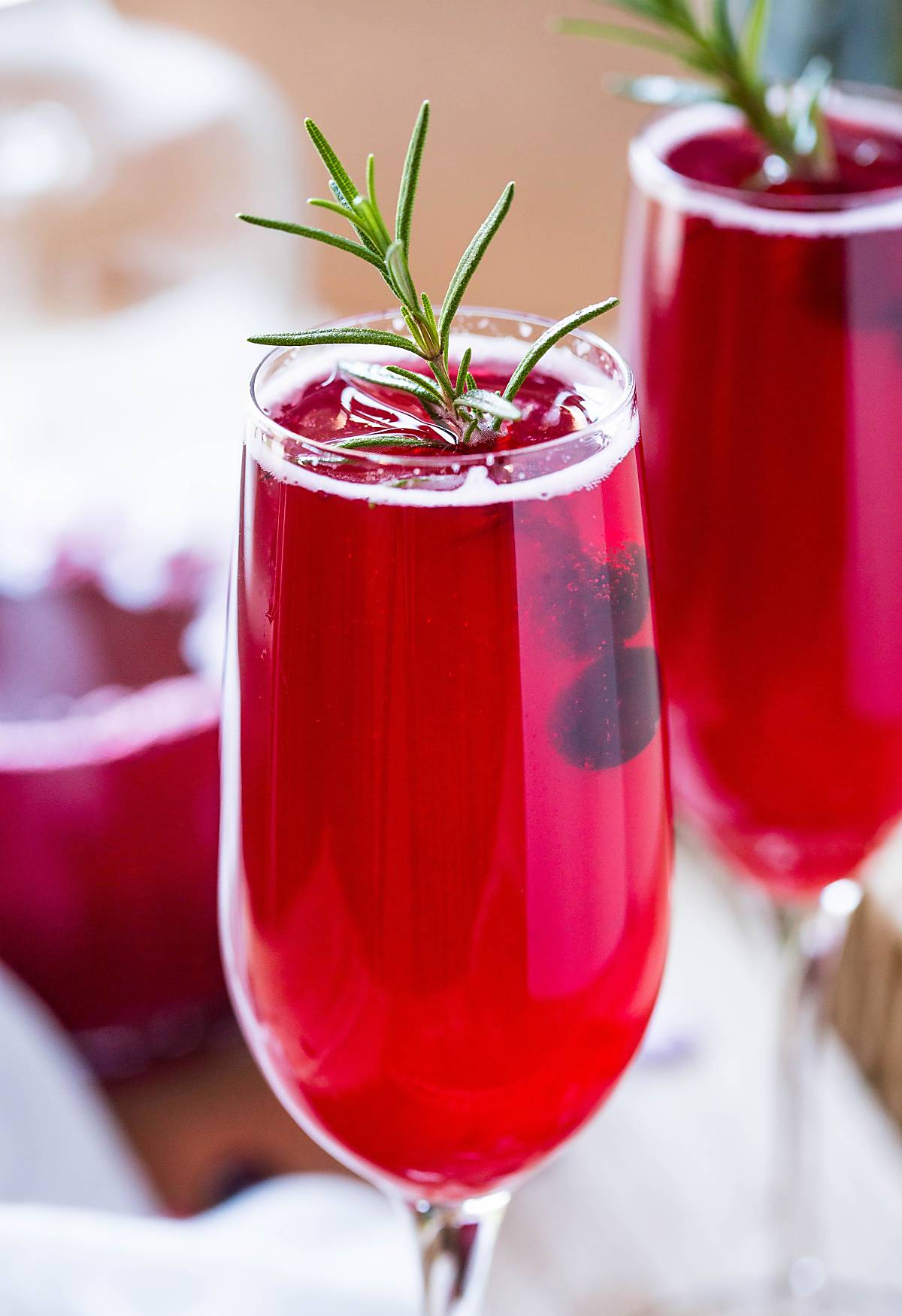 Non-alcoholic cranberry mimosa served in champagne flutes.