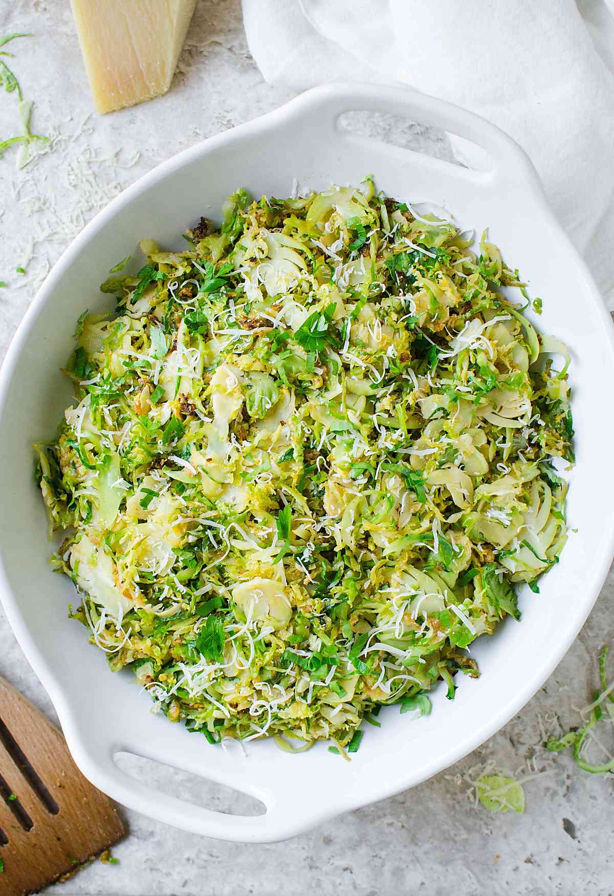 shredded and sauteed garlic parmesan brussels sprouts in a serving bowl.