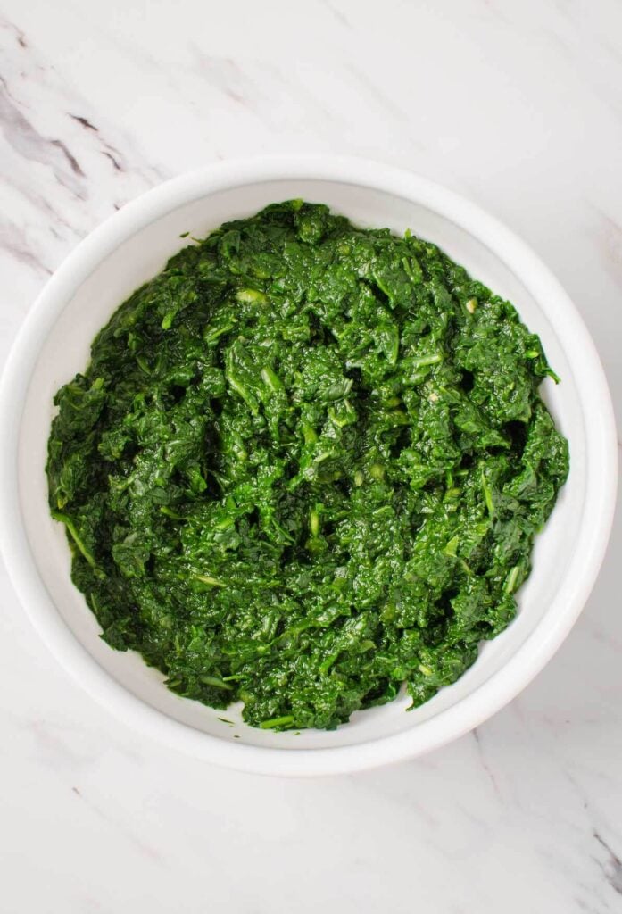 Spinach puree in a white ceramic bowl for making palak paneer rice.