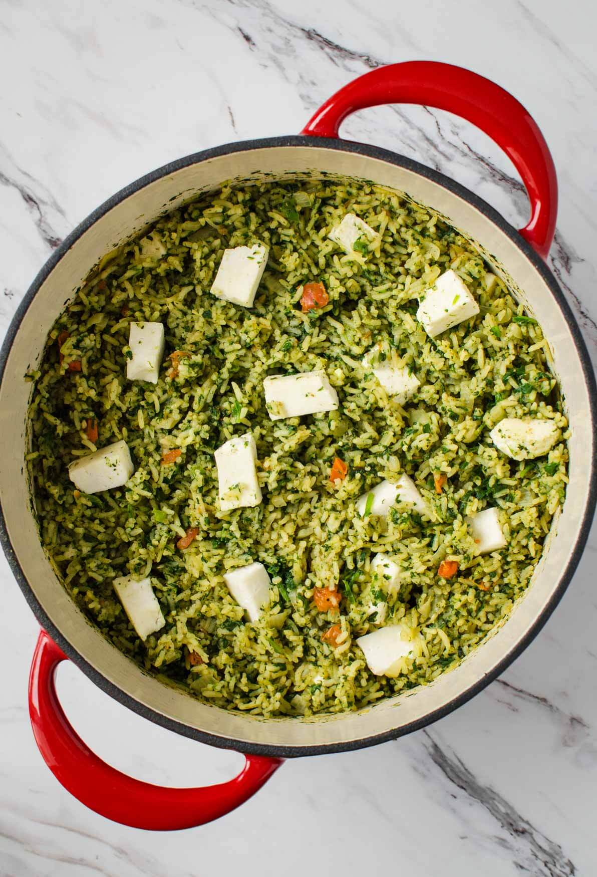 Palak paneer rice in a metal dutch over. 