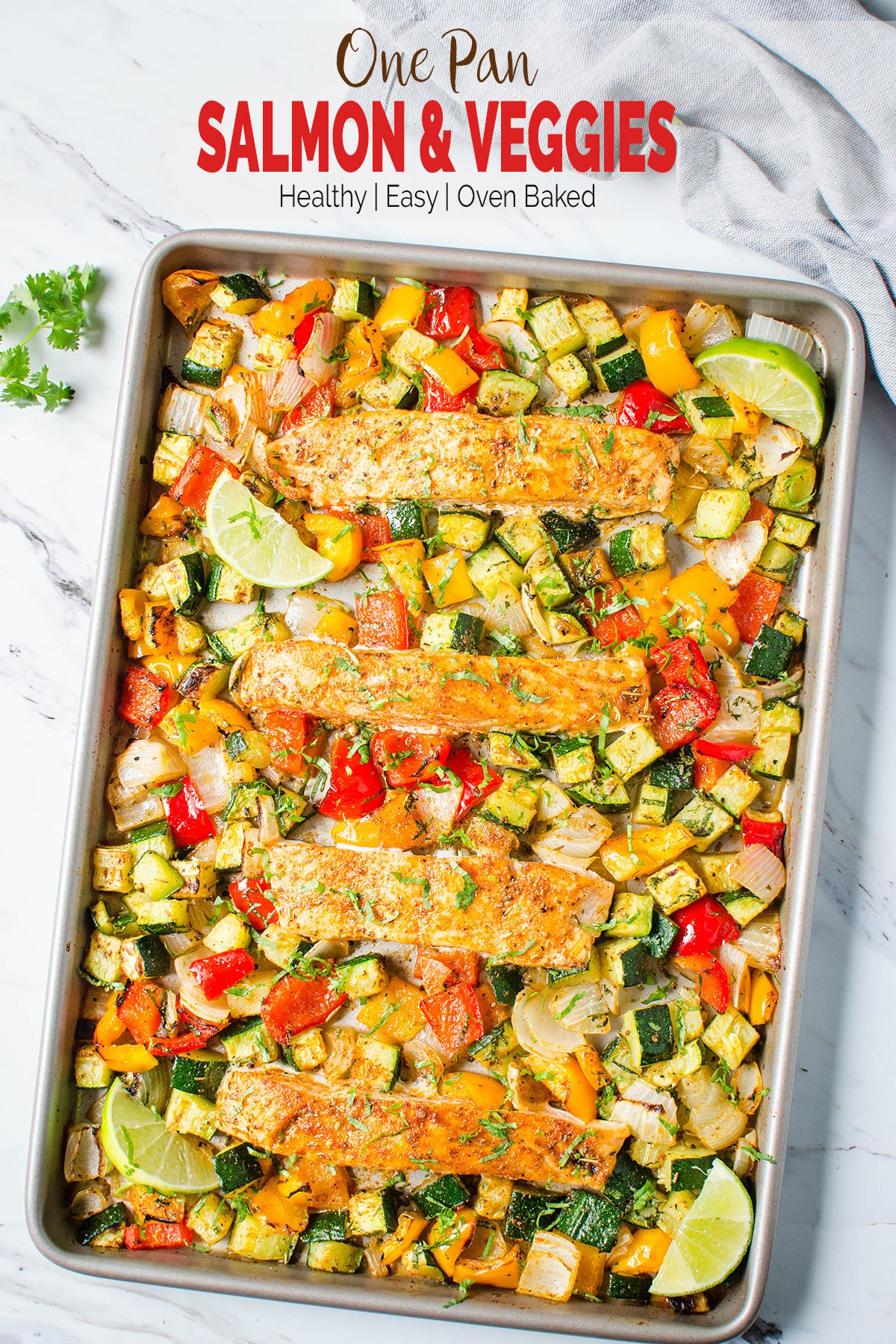 Salmon and vegetables baked together in one pan for an easy, healthy and quick dinner. Get the grilled look on veggies and salmon in the oven. And for a gluten-free meal serve with brown rice or quinoa. | #watchwhatueat #salmon #onepan #healthydinner #healthyrecipes