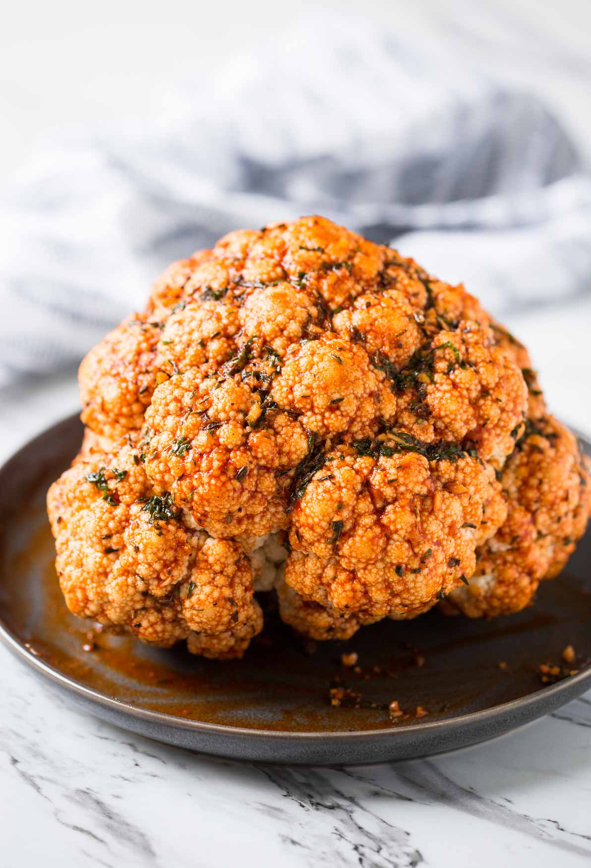 Whole cauliflower head marinated with spice mixture to cook in the Instant Pot.