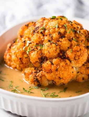 Healthy Instant Pot Cauliflower - cook whole cauliflower head in the pressure cooker and serve with delicious creamy gravy to make it more flavorful. Perfect vegetarian and vegan recipe for the holiday dinner or weeknight healthy meal. | #watchwhatueat #veganthanksgiving #vegan #cauliflower