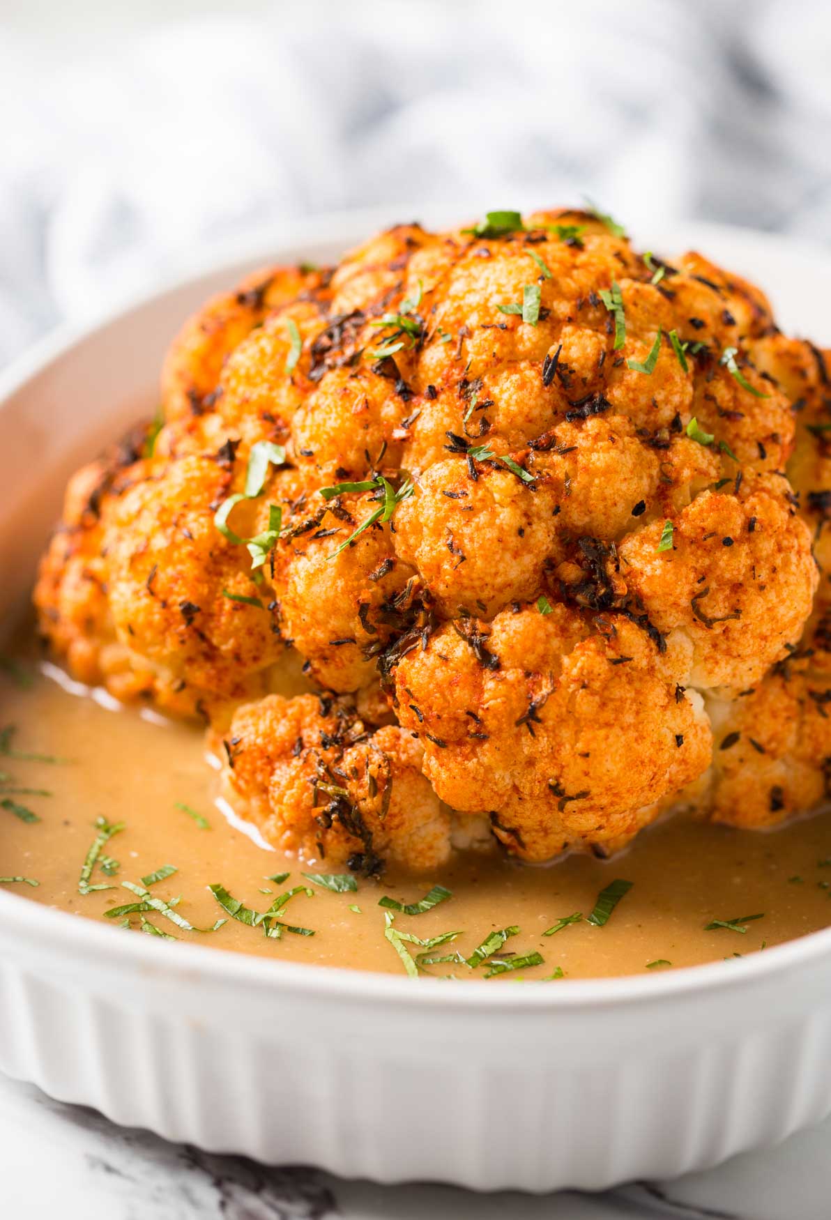 Healthy Instant Pot Cauliflower - cook whole cauliflower head in the pressure cooker and serve with delicious creamy gravy to make it more flavorful. Perfect vegetarian and vegan recipe for the holiday dinner or weeknight healthy meal. | #watchwhatueat #veganthanksgiving #vegan #cauliflower