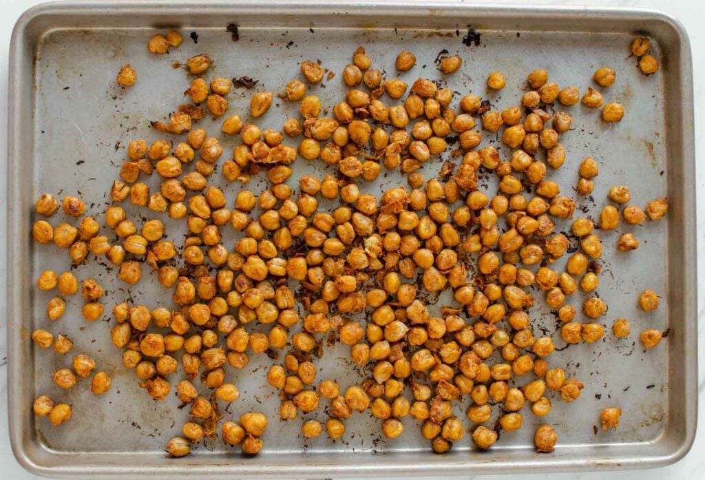 Roasted chickpeas in a baking tray after baking. 