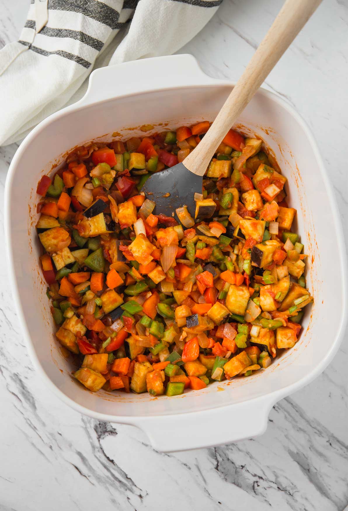 Sauteing fresh veggies in tomato sauce for making vegetable pasta soup.