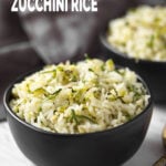 Zucchini rice in a black ceramic bowl.