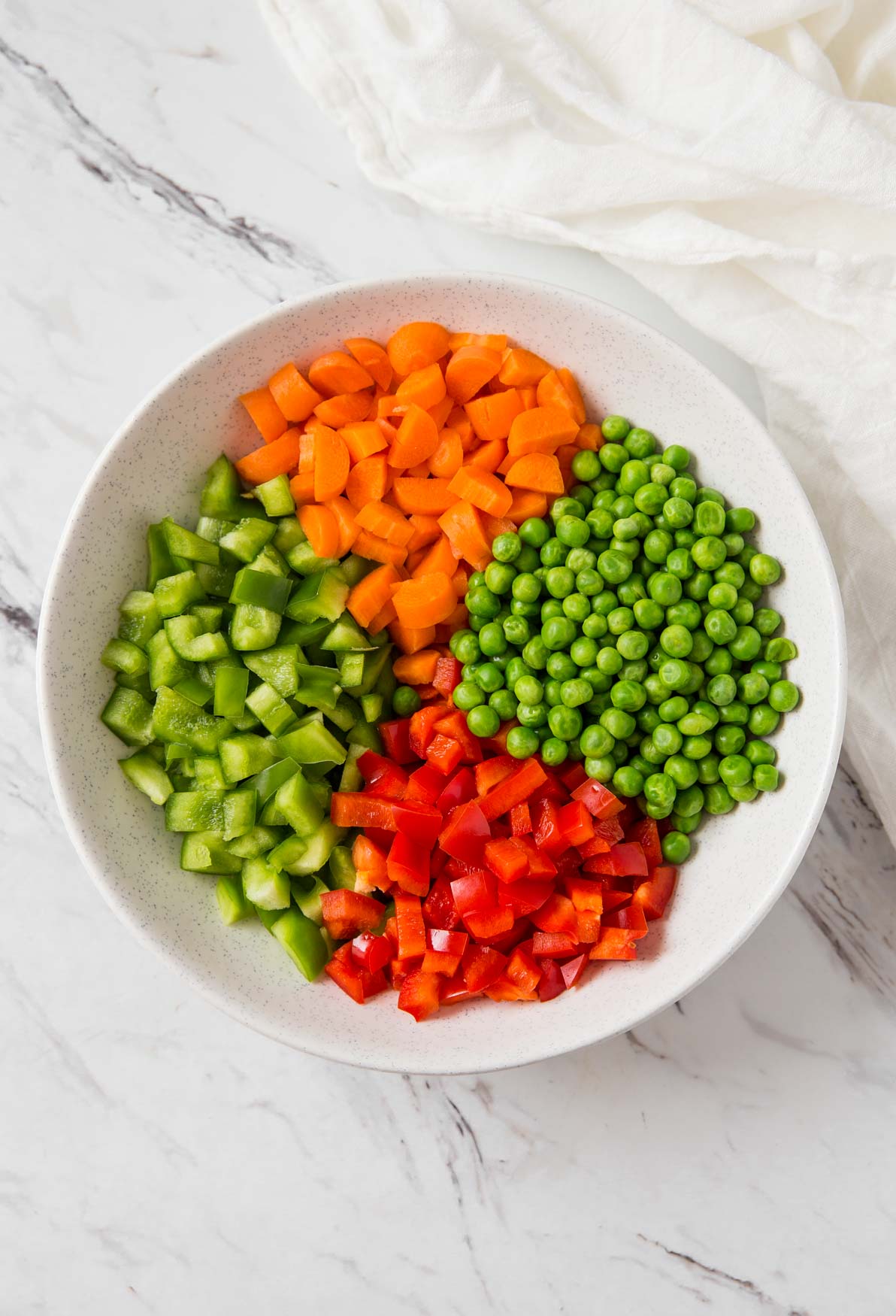 Diced fresh vegetables in a mixing bowl for making vegetable fried rice.