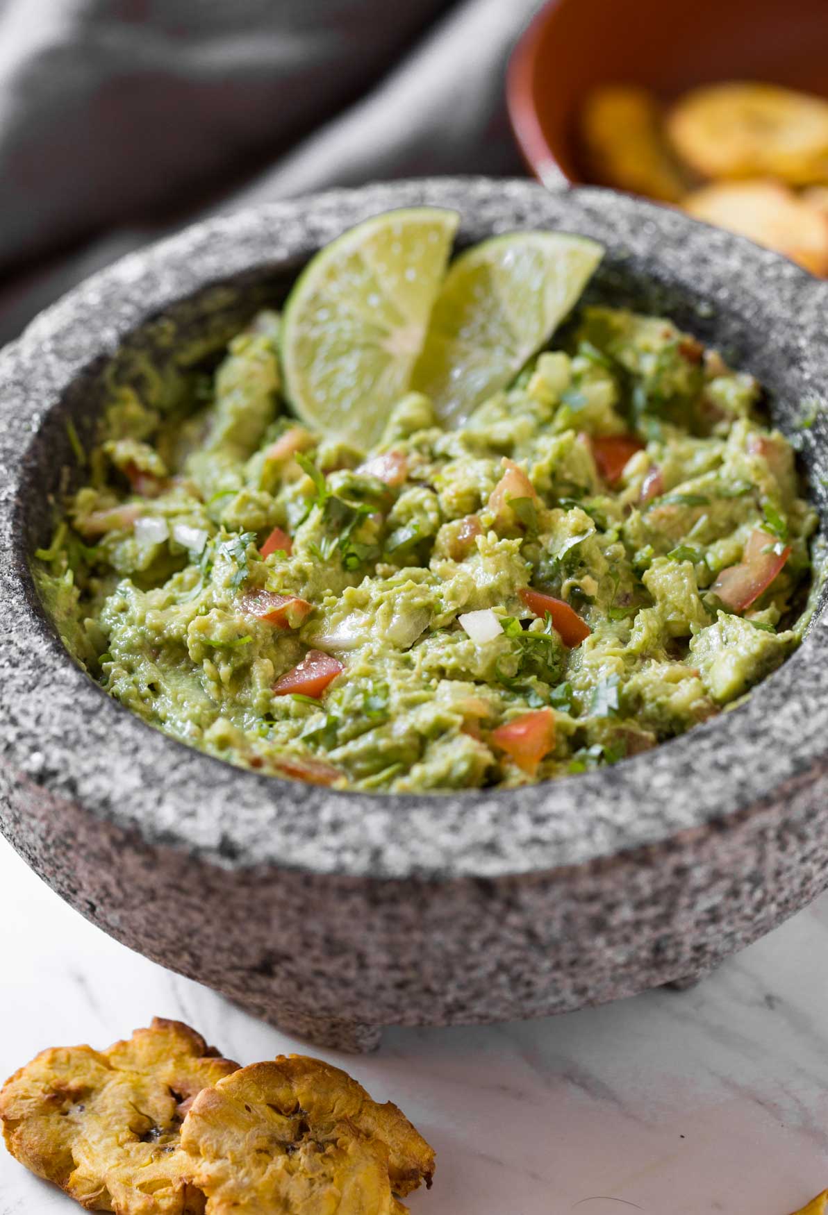 Simple Healthy Guacamole Recipe -- Chunky avocado pulp mixed with fresh chopped tomatoes and onion. Lime juice, fresh cilantro, and seasonings make it even more flavourful.