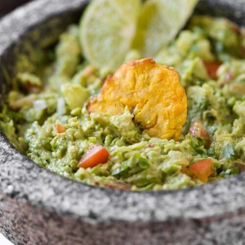 Simple Healthy Guacamole Recipe -- Chunky avocado pulp mixed with fresh chopped tomatoes and onion. Lime juice, fresh cilantro, and seasonings make it even more flavourful.