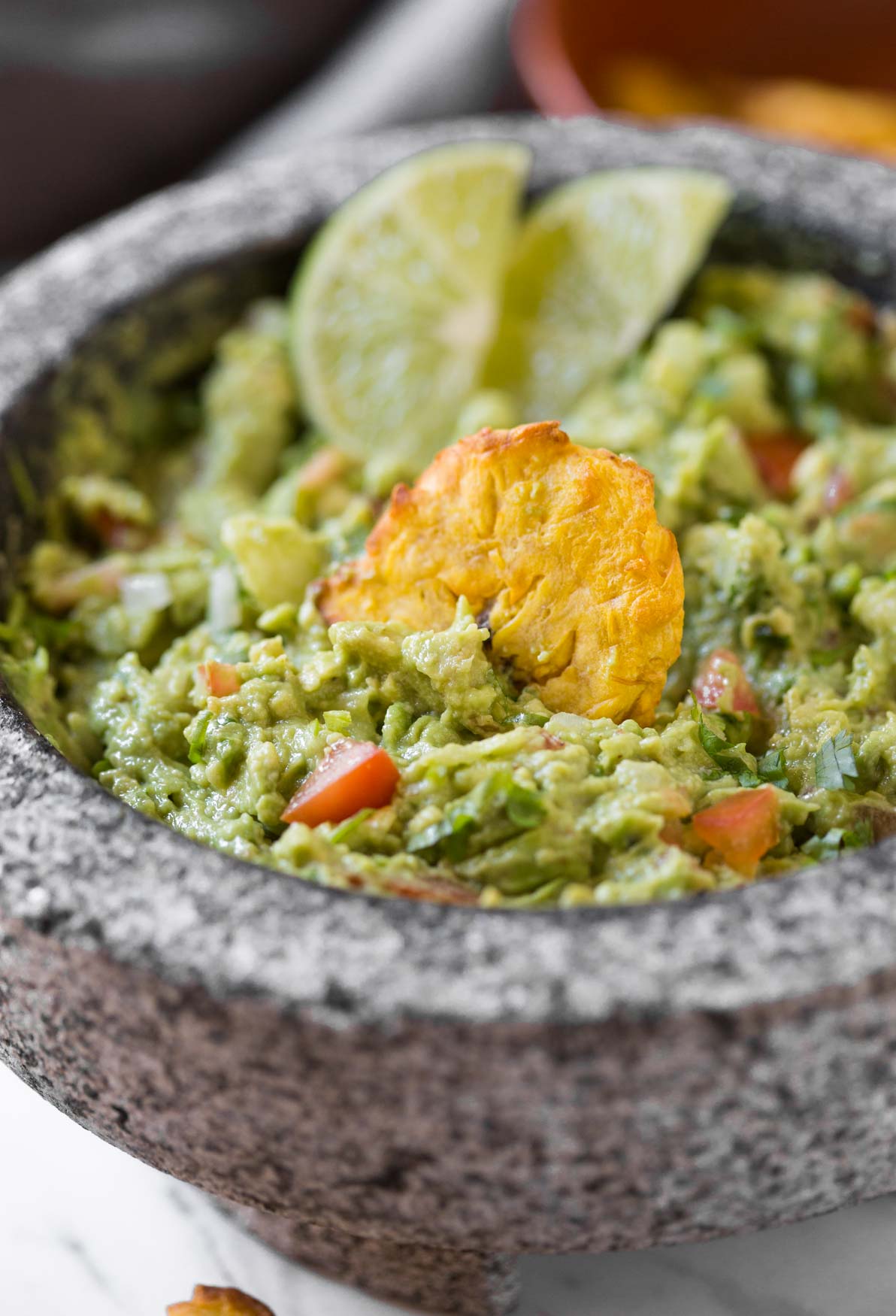 Simple Healthy Guacamole Recipe -- Chunky avocado pulp mixed with fresh chopped tomatoes and onion. Lime juice, fresh cilantro, and seasonings make it even more flavourful.