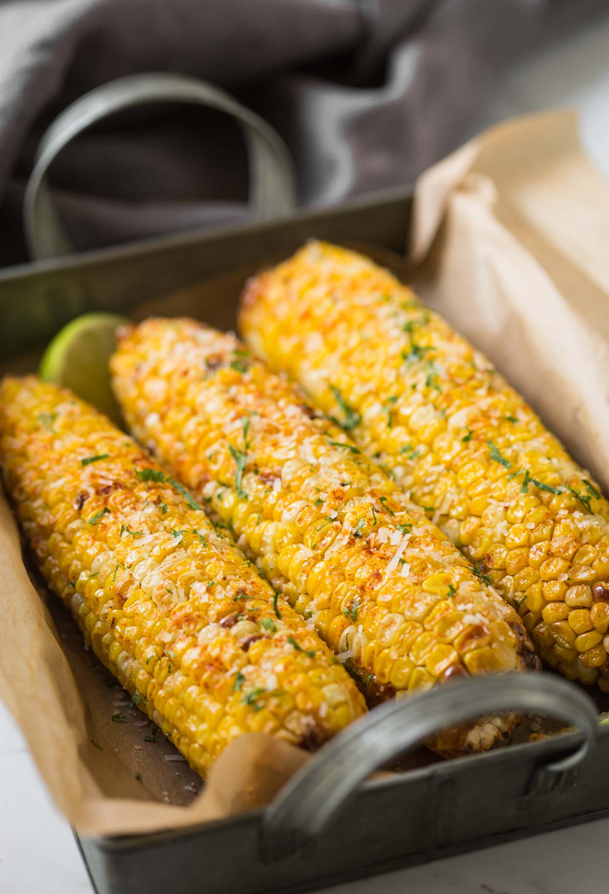 Quick and easy Air fryer corn on the cob flavored with herbs and parmesan.