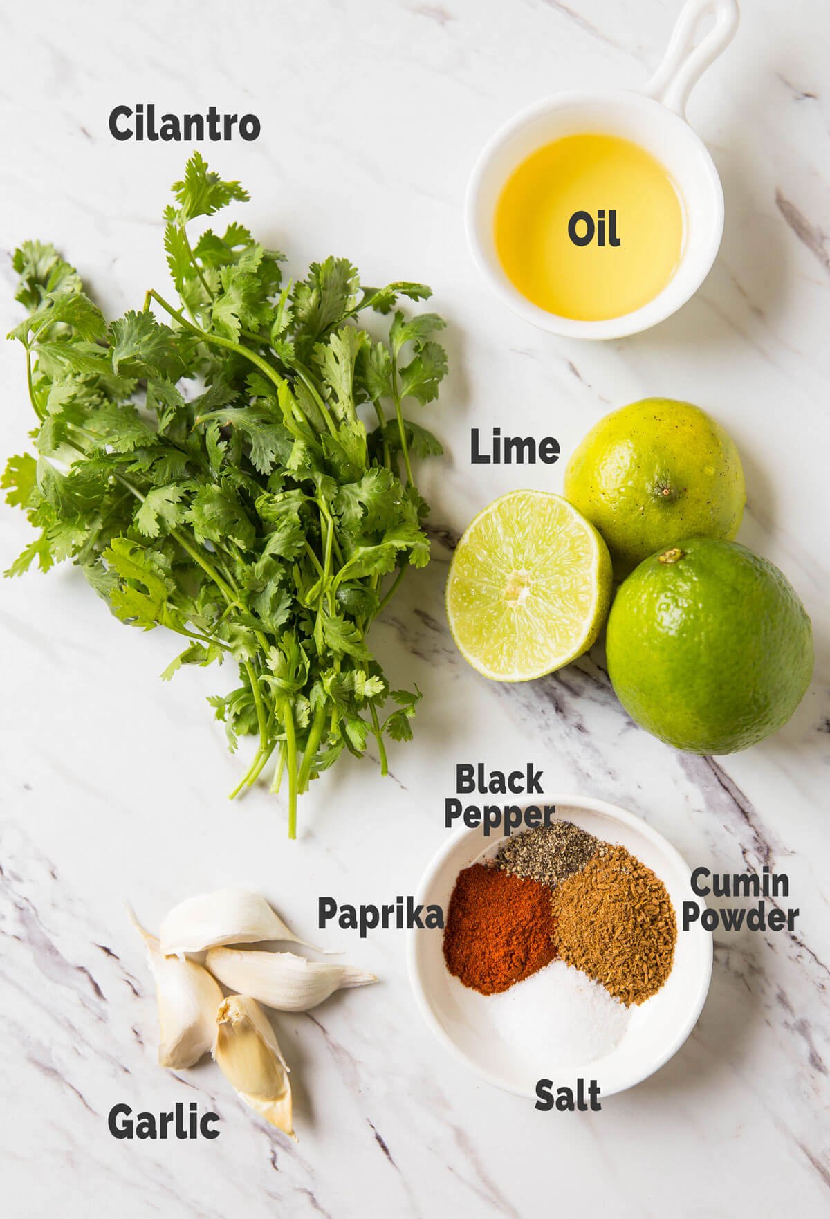 Different ingredients for preparing garlic cilantro lime marinade.