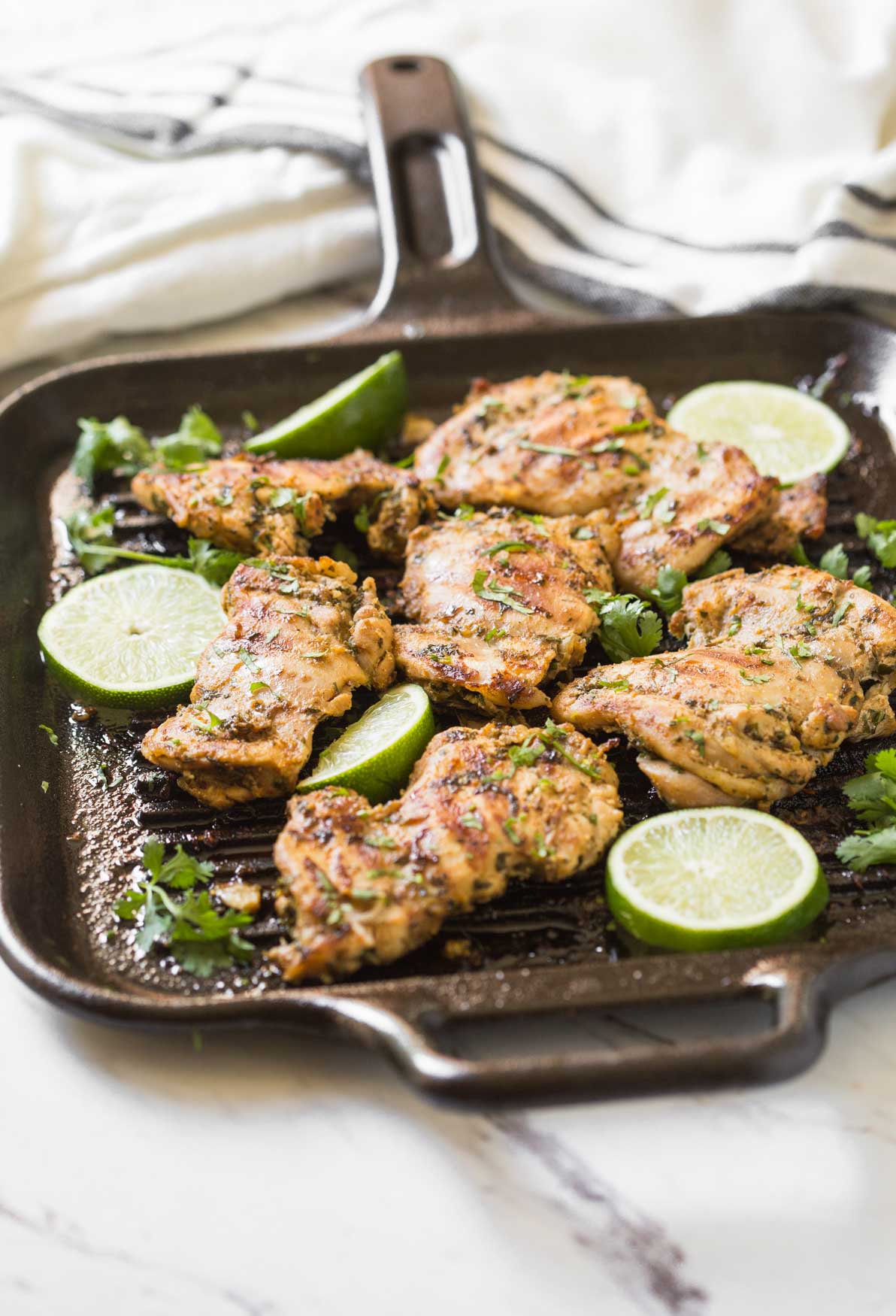 This grilled cilantro lime chicken thighs recipe is perfect to add in the outdoor barbecue party menu during summer. Prep ahead in no time and take them to barbecue potlucks. Or just cook marinated chicken on the grill or frying pan for the weeknight dinner. | #watchwhatueat #grilledchicken #cilantrolime #grilling #chickenthighs