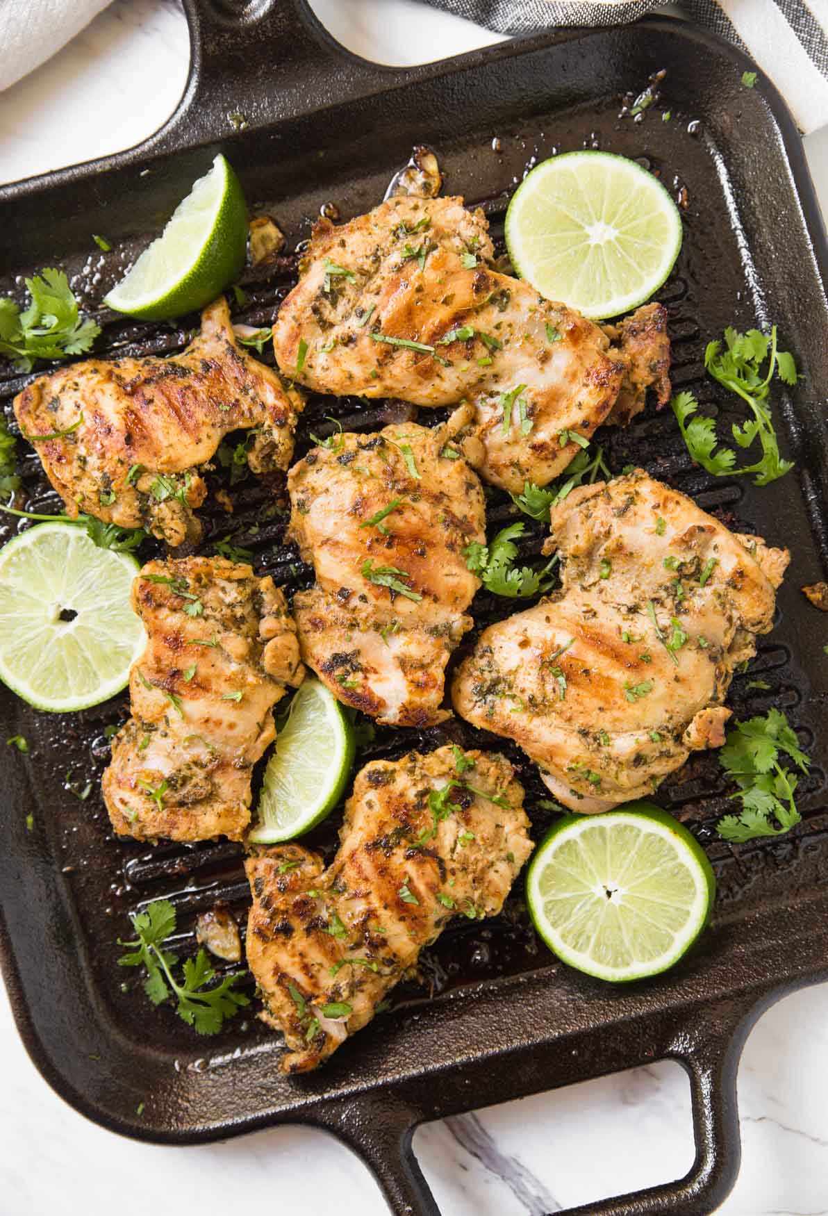 Prepare these cilantro lime grilled chicken thighs with delicious and healthy marinade. A quick and easy prep-ahead recipe perfect for a grilling party. Or just cook marinated chicken on the grill or frying pan for the weeknight dinner. | #watchwhatueat #grilledchicken #cilantrolime #grilling #chickenthighs