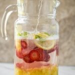 This pineapple strawberry sangria is a perfect non-alcoholic summer drink to enjoy fresh seasonal fruits and beat the summer heat. It is prepared using fresh strawberries and pineapple. | #watchwhatueat #nonalcoholic #summerdrink #strawberry #nonalcoholicsangria #sangria