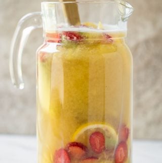 This pineapple strawberry sangria is a perfect non-alcoholic summer drink to enjoy fresh seasonal fruits and beat the summer heat. It is prepared using fresh strawberries and pineapple. | #watchwhatueat #nonalcoholic #summerdrink #strawberry #nonalcoholicsangria #sangria