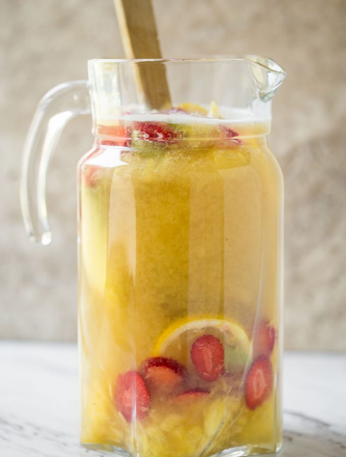 This pineapple strawberry sangria is a perfect non-alcoholic summer drink to enjoy fresh seasonal fruits and beat the summer heat. It is prepared using fresh strawberries and pineapple. | #watchwhatueat #nonalcoholic #summerdrink #strawberry #nonalcoholicsangria #sangria