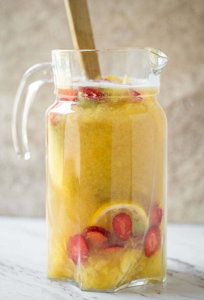 This pineapple strawberry sangria is a perfect non-alcoholic summer drink to enjoy fresh seasonal fruits and beat the summer heat. It is prepared using fresh strawberries and pineapple. | #watchwhatueat #nonalcoholic #summerdrink #strawberry #nonalcoholicsangria #sangria