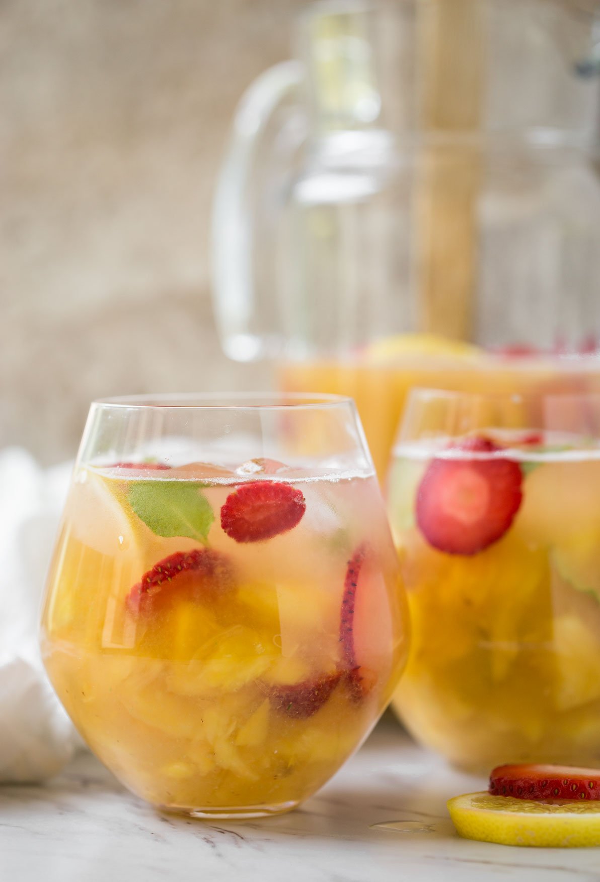 Non alcoholic pineapple strawberry sangria in serving glasses.