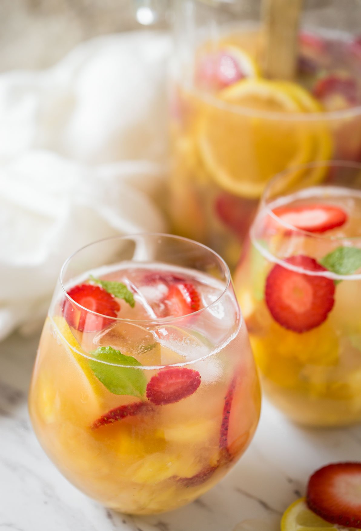 Non alcoholic pineapple strawberry sangria in serving glasses.