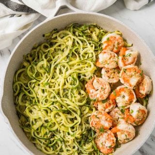 Shrimps and zucchini noodles cooked in fresh garlic and lemon juice and topped with finely chopped fresh herbs